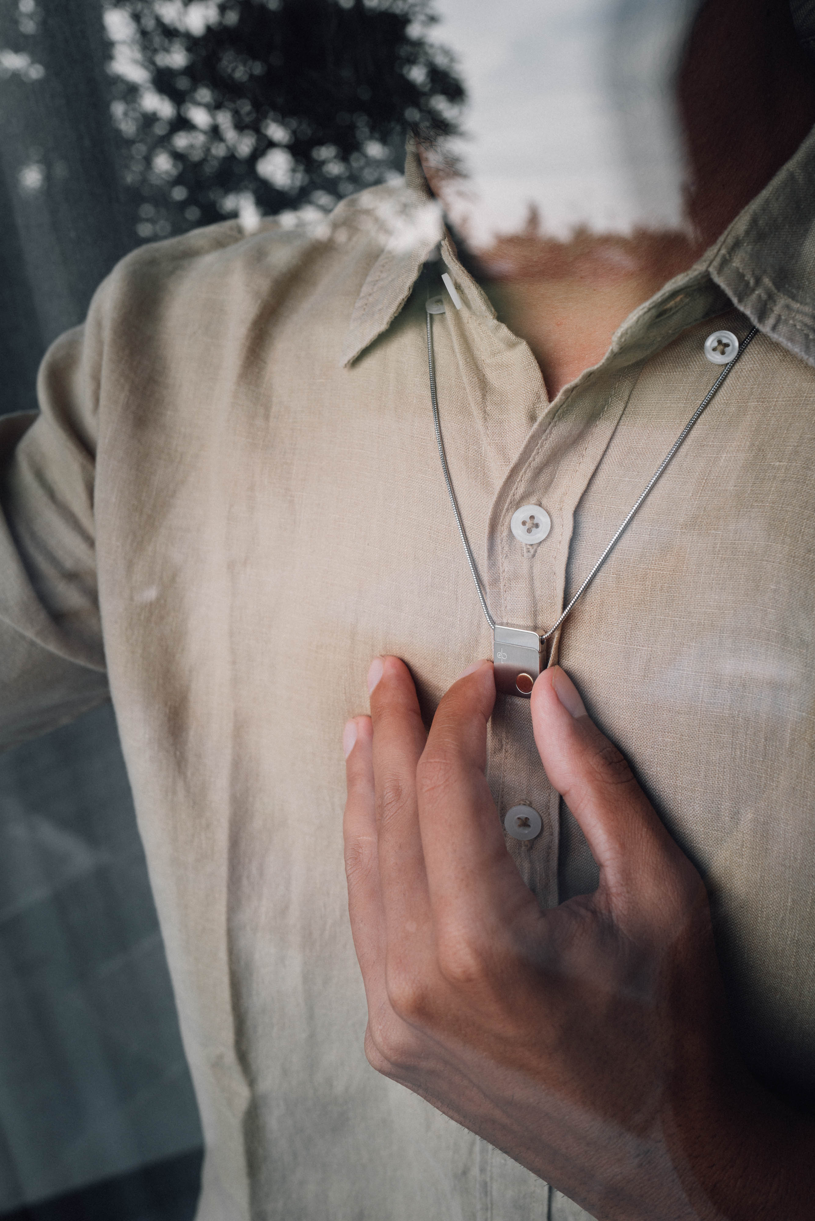 Man wearing QiOne 2 Pro Necklace
